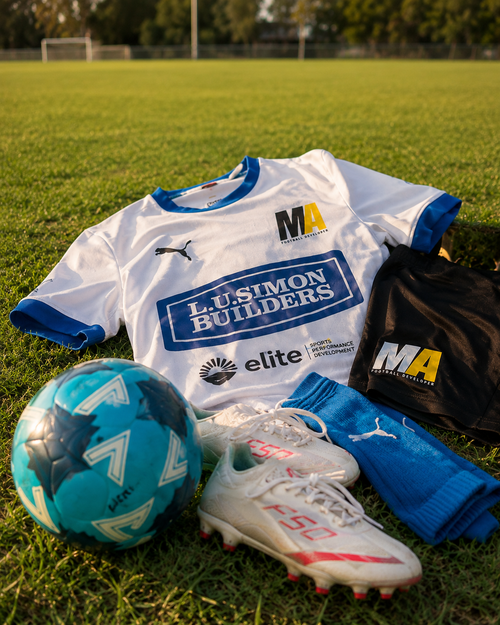 MAFD Puma youth football training kit with jersey, shorts, socks, boots and ball on grass